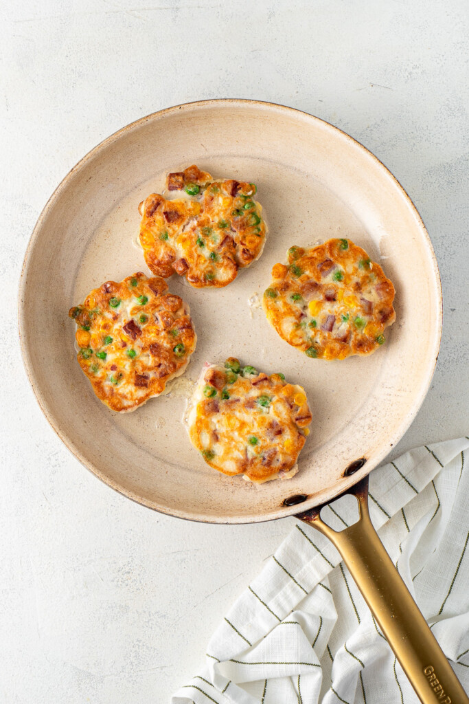 Crispy fritters cooked in a pan.