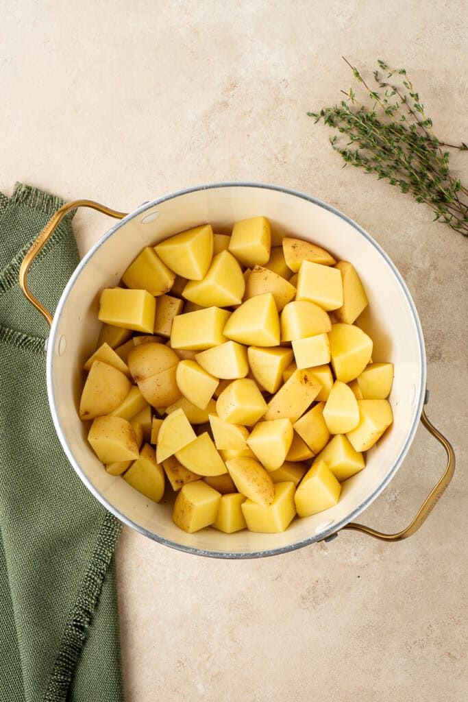Chopped potatoes in a stock pot.