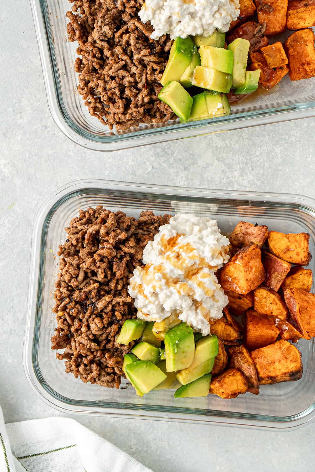 Meal prep containers with hot honey beef and sweet potato.