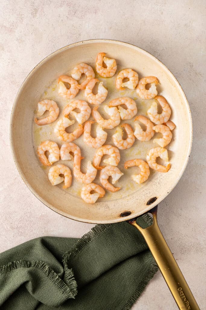 Cooking the prawns in a frying pan.
