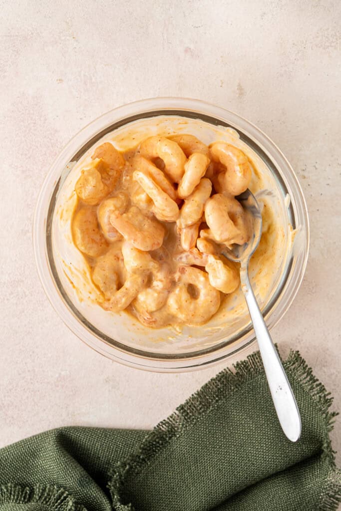 Mixing the cooked prawns with the spicy mayo.