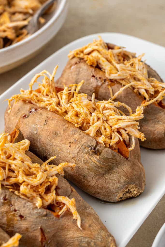 Filling the sweet potatoes with buffalo chicken.