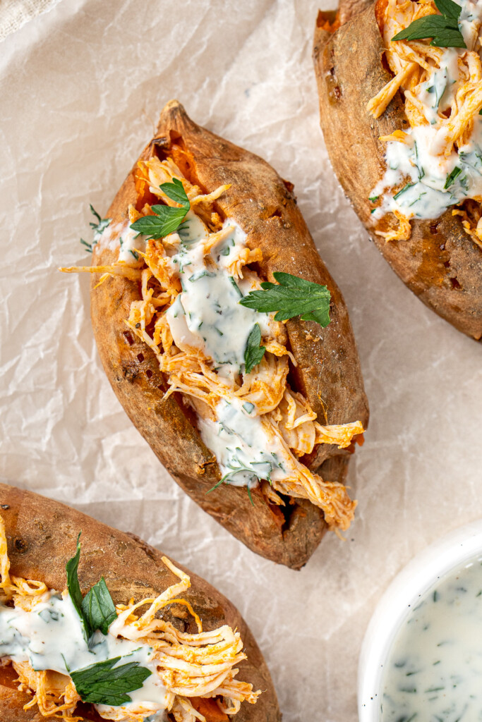 Serving suggestion of buffalo chicken stuffed sweet potatoes.