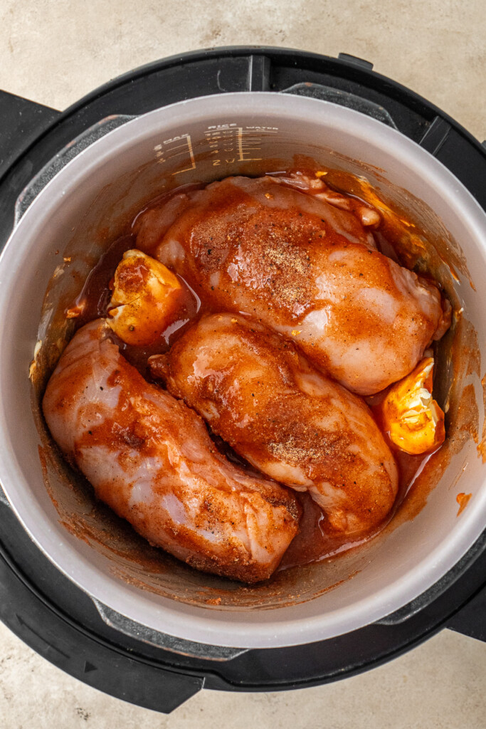 The chicken and sauce in the slow cooker.