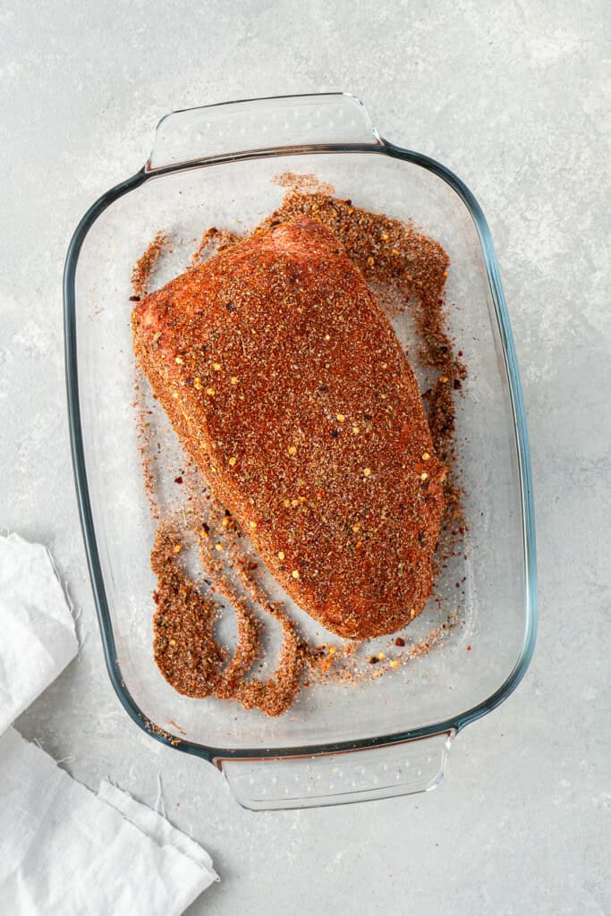 Rubbing the spice mix on the chuck roast.