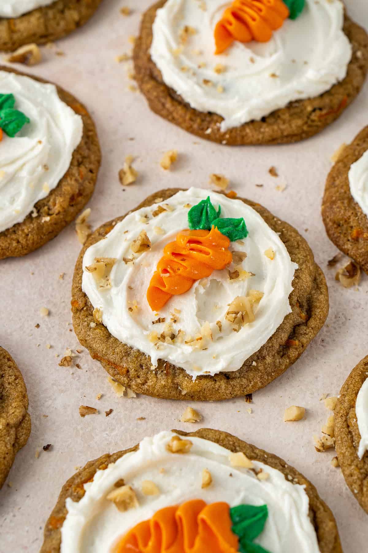 The decorated carrot cake cookies with chopped walnuts.