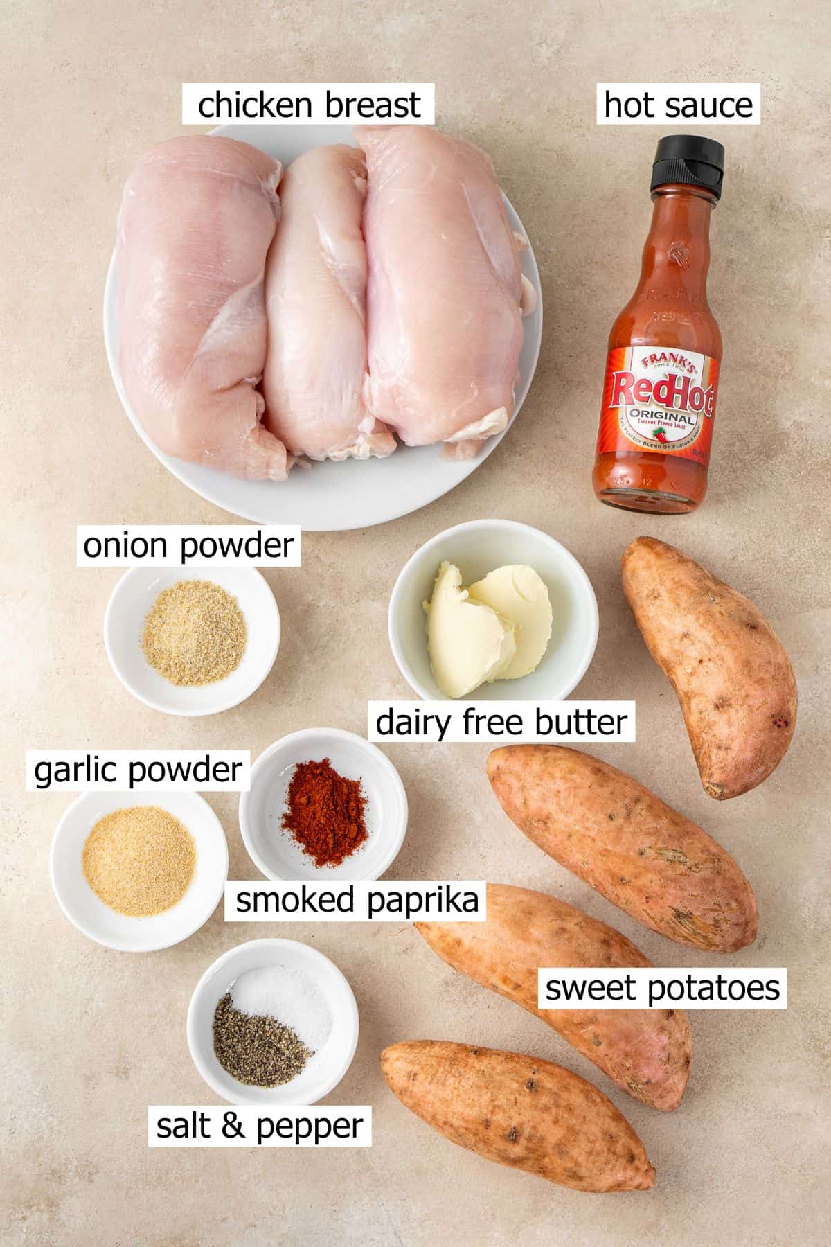 All ingredients needed to make buffalo chicken stuffed sweet potatoes laid out in bowls.