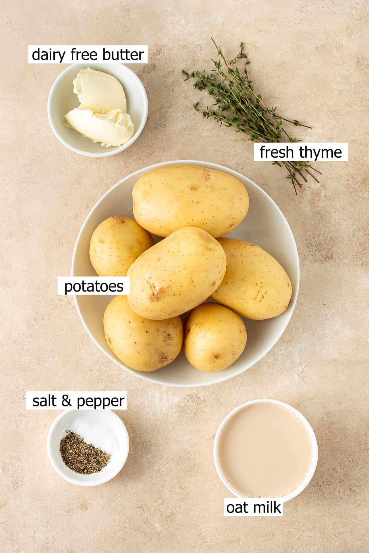 All ingredients needed to make dairy free mashed potatoes laid out in bowls.