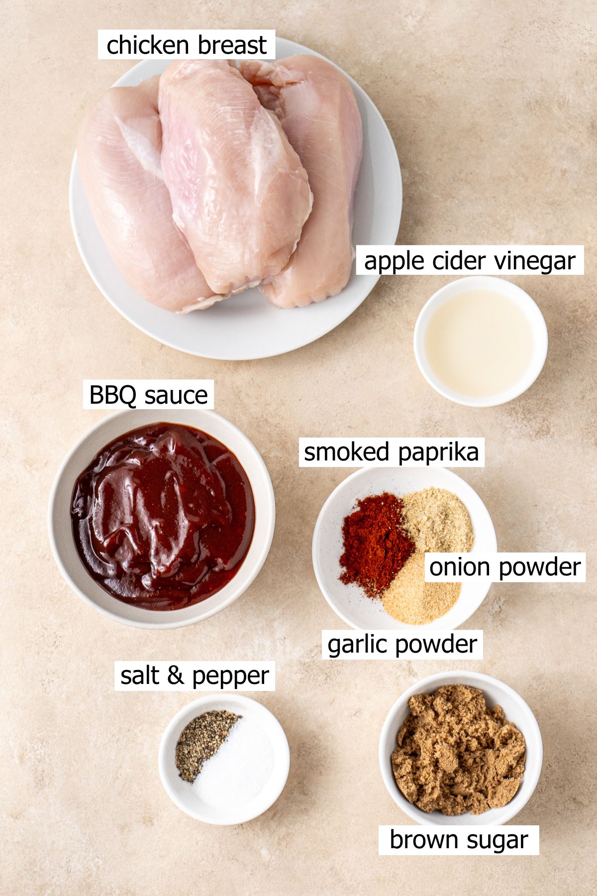 All ingredients needed to make slow cooker BBQ chicken laid out in small bowls.