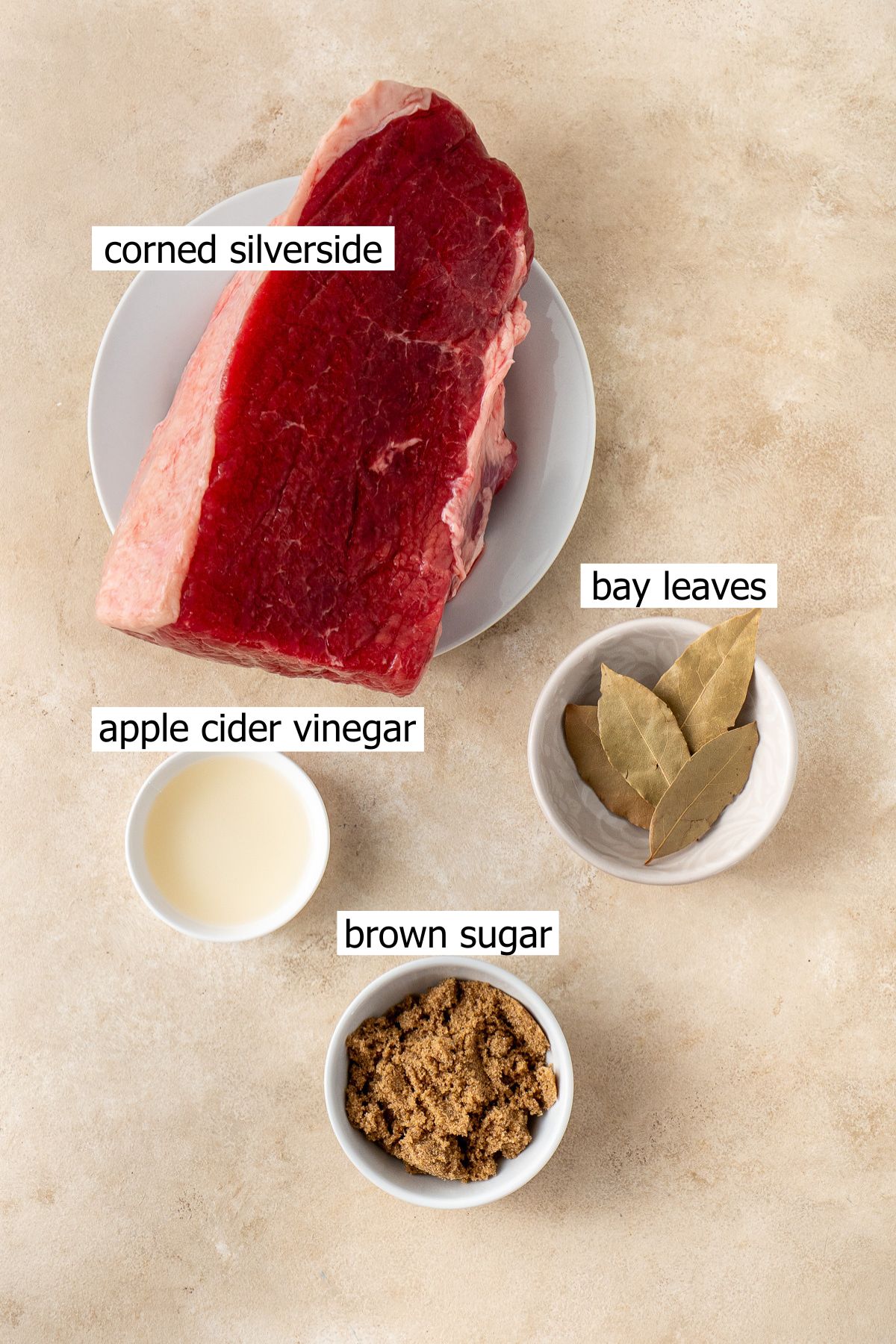 All ingredients needed to make corned beef in the slow cooker laid out.