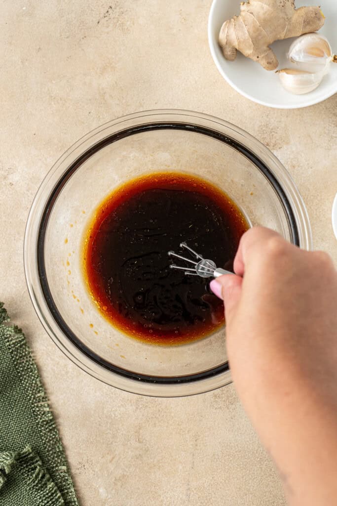 Mixing together the sauce ingredients in a small bowl.