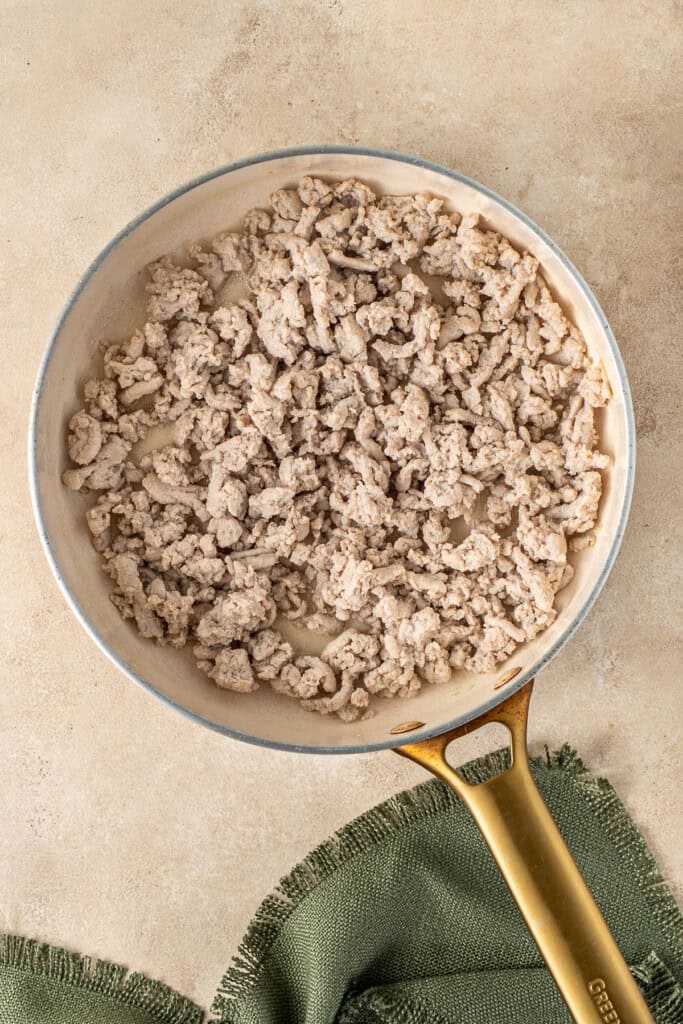 Cooking the chicken mince in a frying pan.