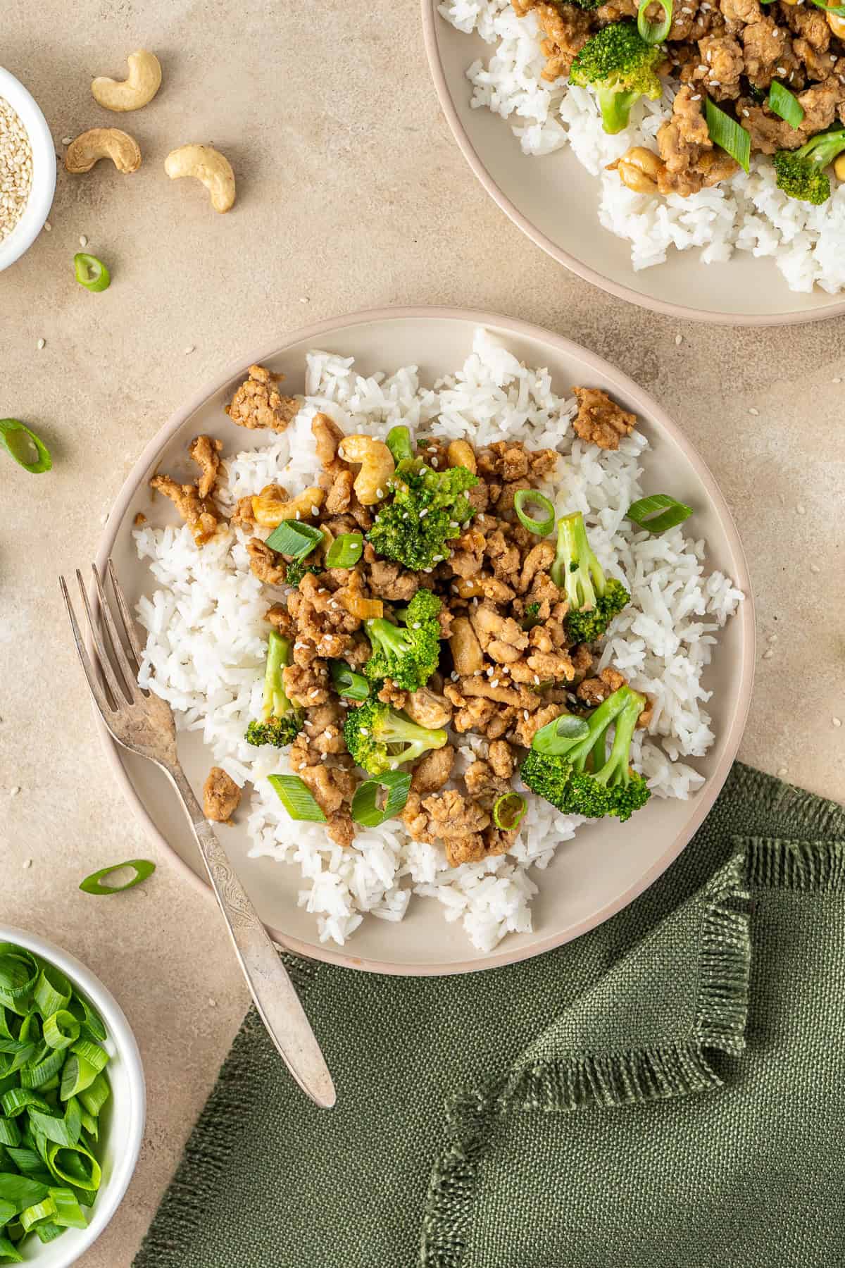 Cashew chicken and broccoli served into a bowl with rice.