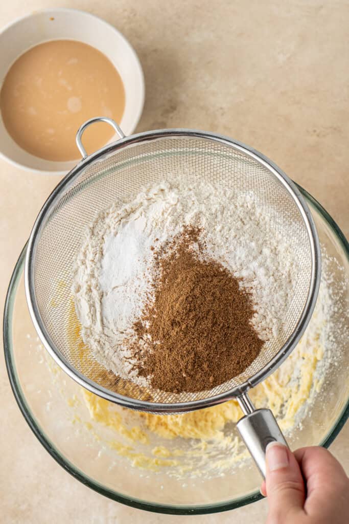 Sifting the dry ingredients into the bowl.
