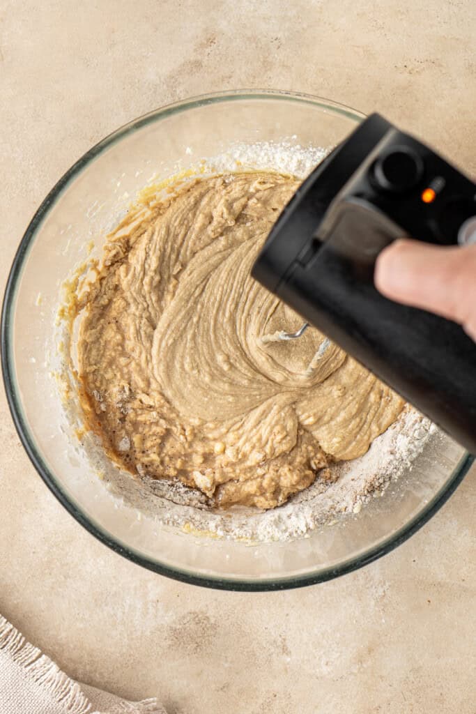 Mixing the cake batter with an electric mixer.