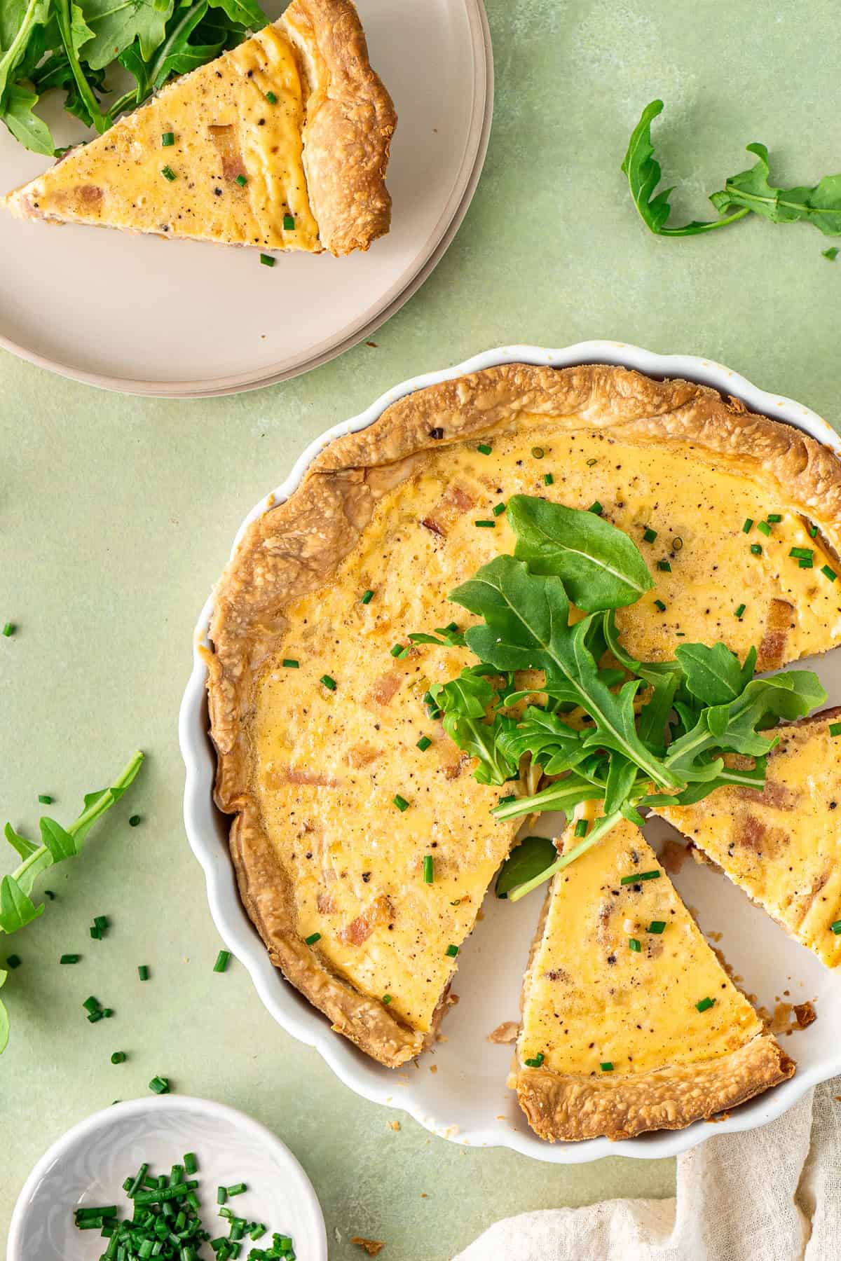 Dairy free quiche cut into slices and served with salad. 