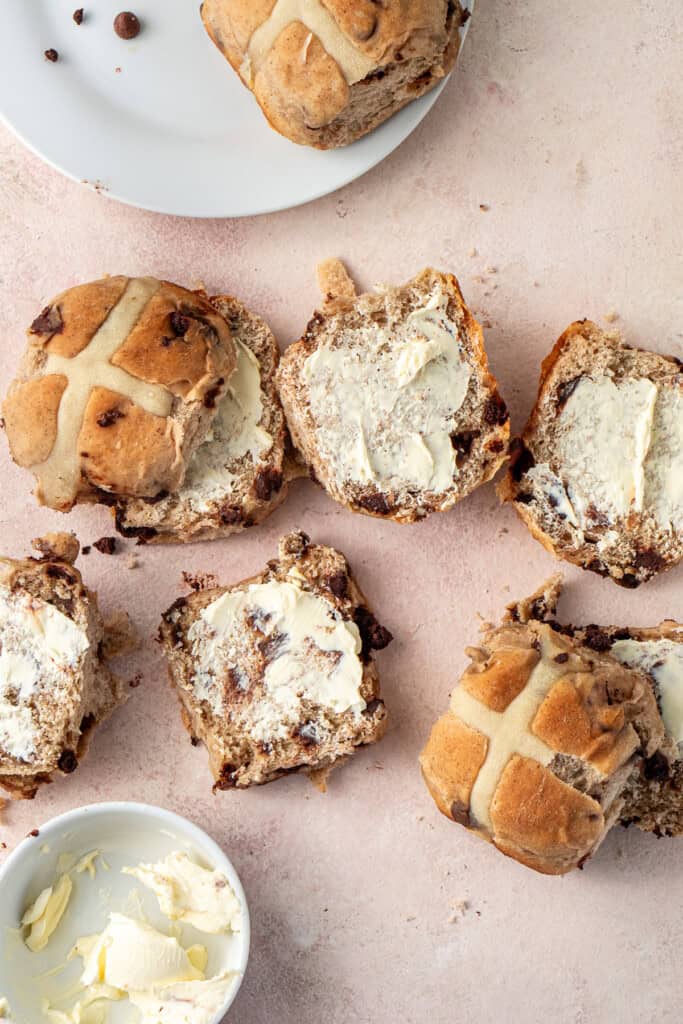 Splitting and buttering the choc chip hot cross buns.