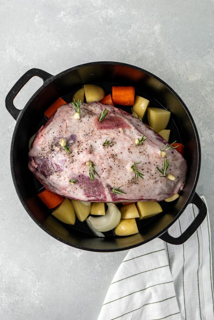 The lamb and vegetables in the pot.