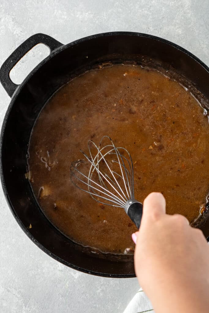 Whisking the gravy.