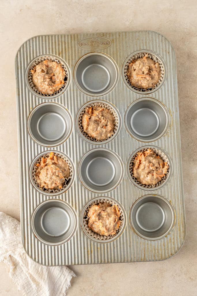 Muffin batter in a muffin pan.
