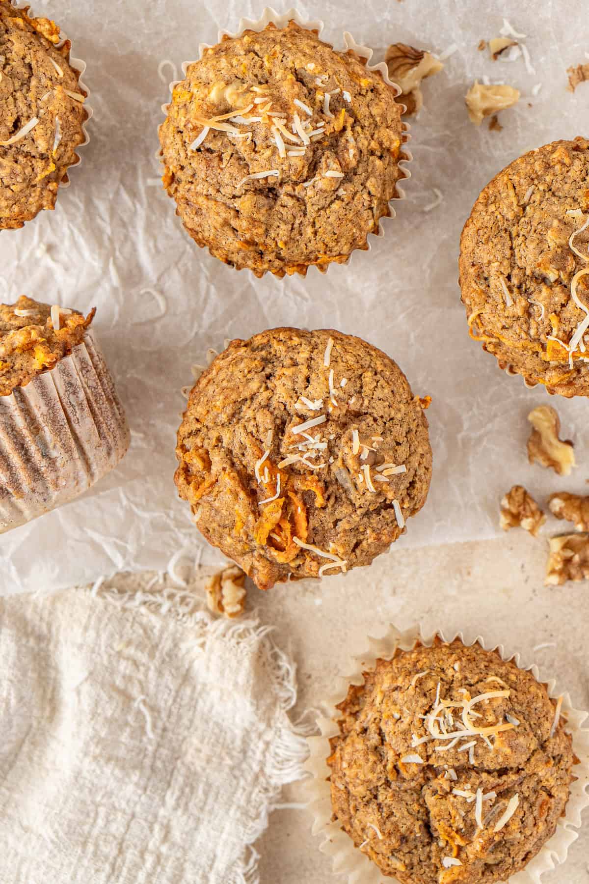 Lots of carrot cake muffins laid out.