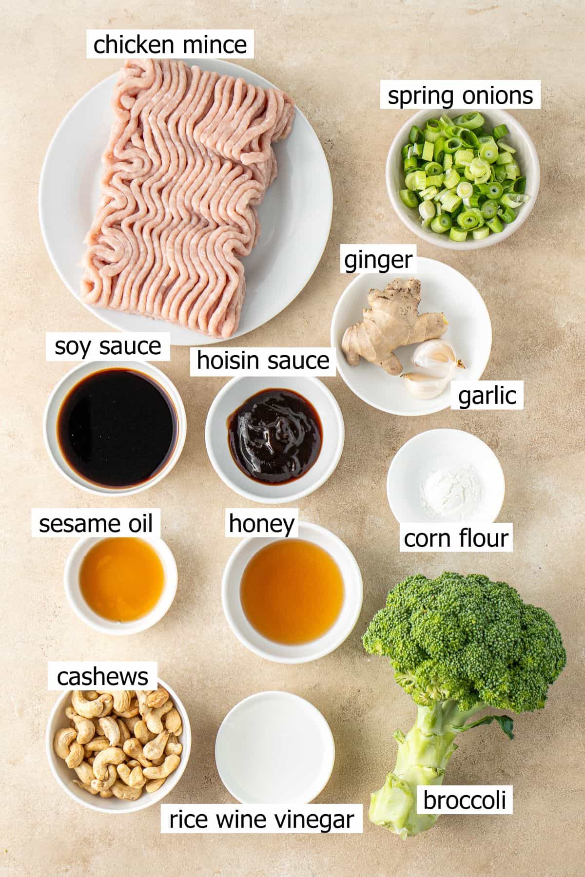All ingredients needed to make cashew chicken and broccoli laid out in small bowls.