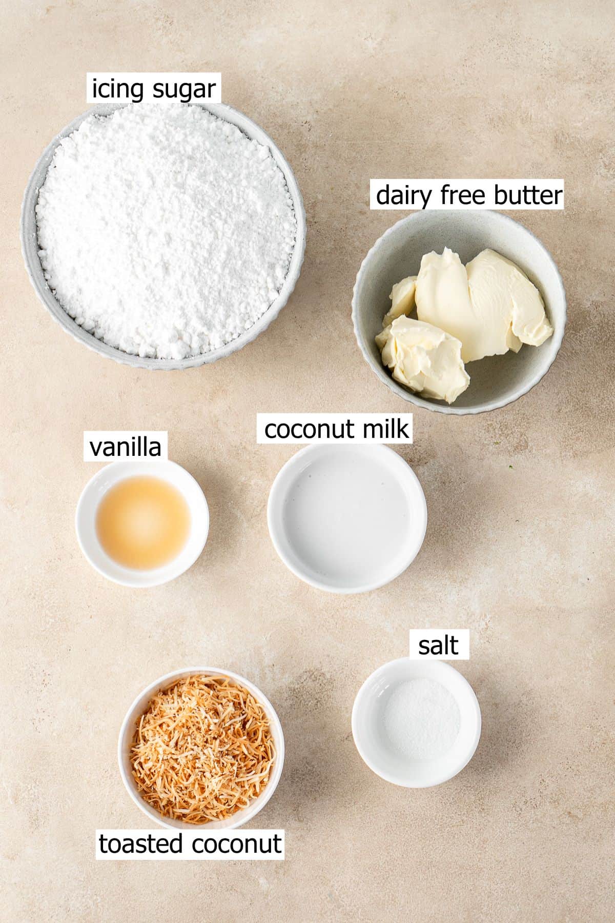 ALl ingredients needed to make vegan coconut buttercream laid out in bowls.