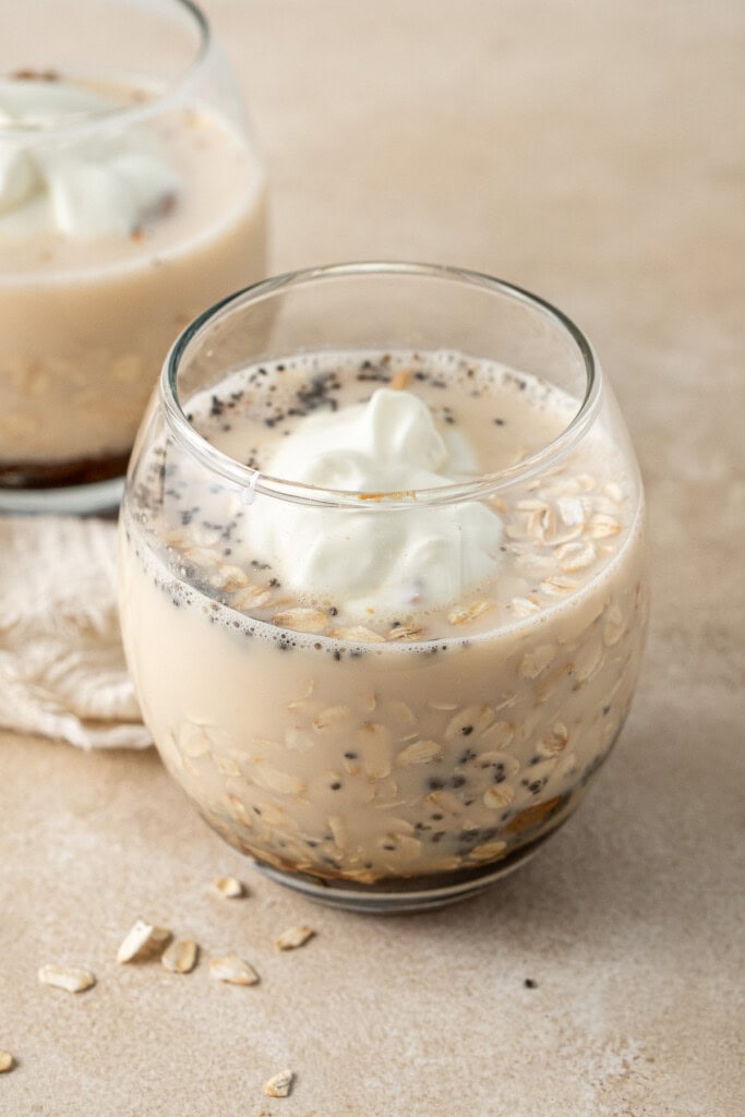 Adding all of the ingredients to a glass.