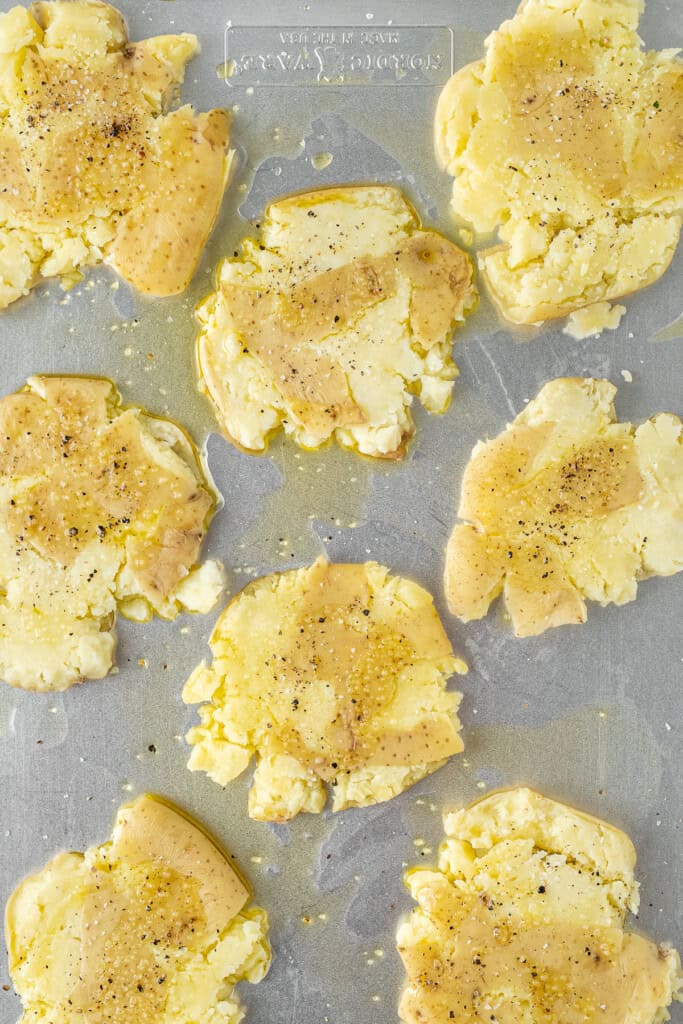 The smashed potatoes coated in oil.