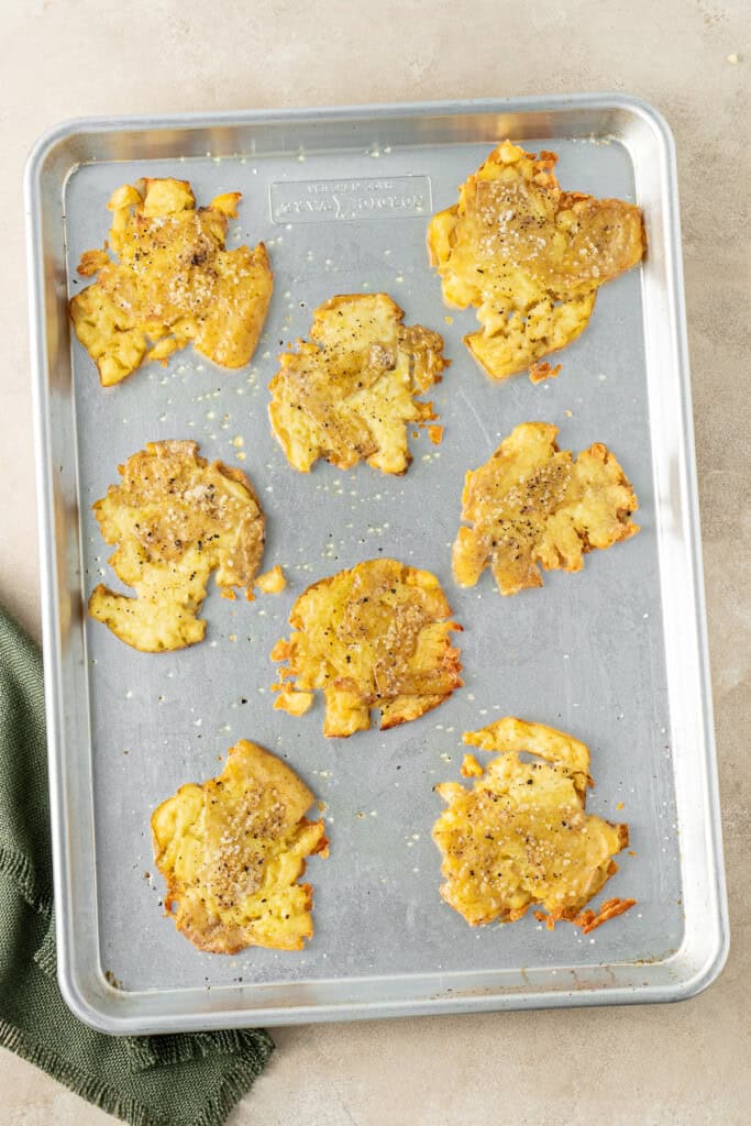 Crispy potatoes straight from the oven on a tray.