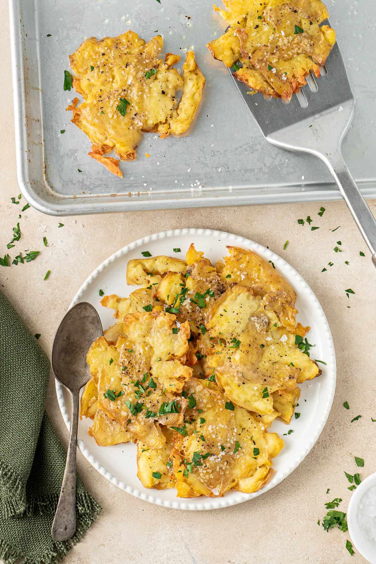 Crispy smashed potatoes served up on a plate.