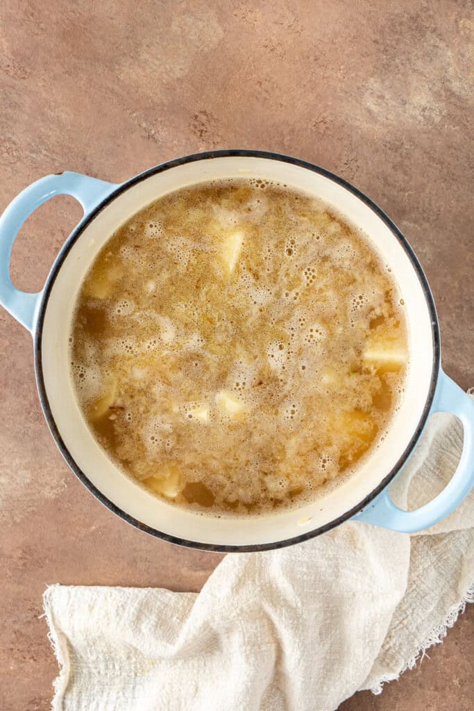 The potatoes boiling in the stock.