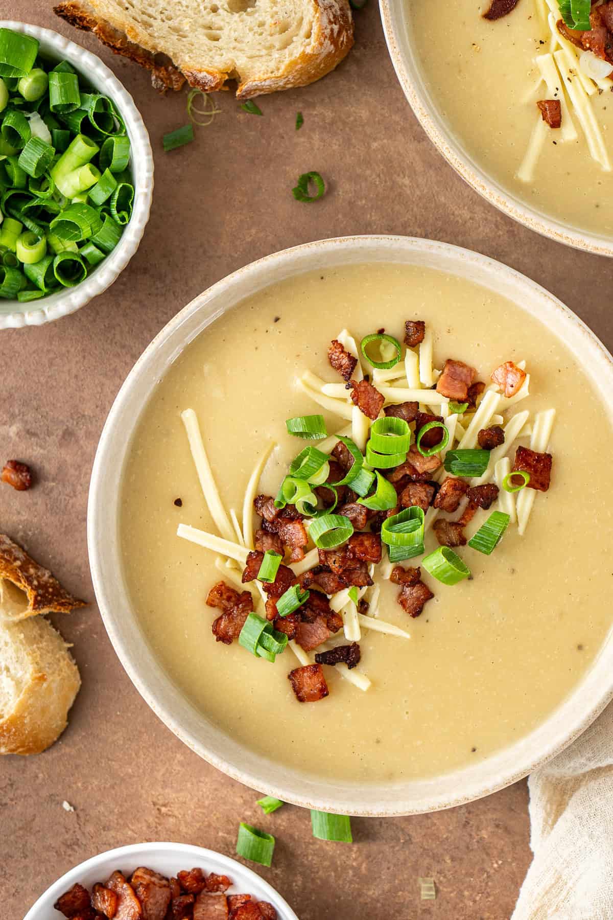 Close up of the baked potato soup with loaded toppings.