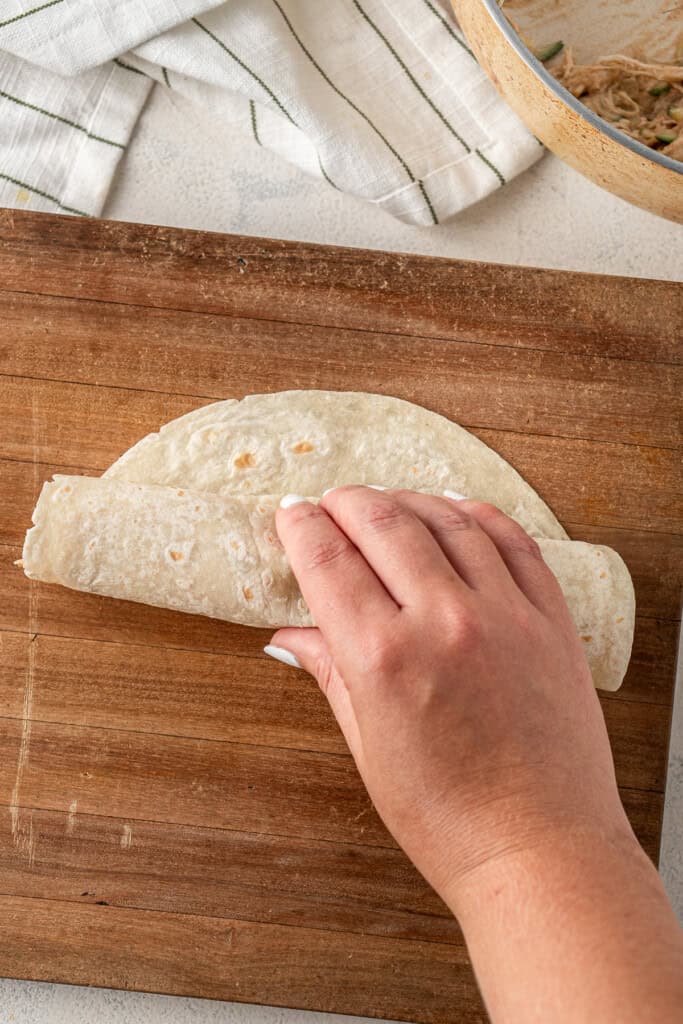Rolling up the tortilla.