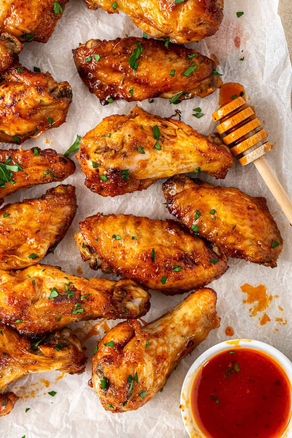 Close up of hot honey chicken wings with extra sauce.
