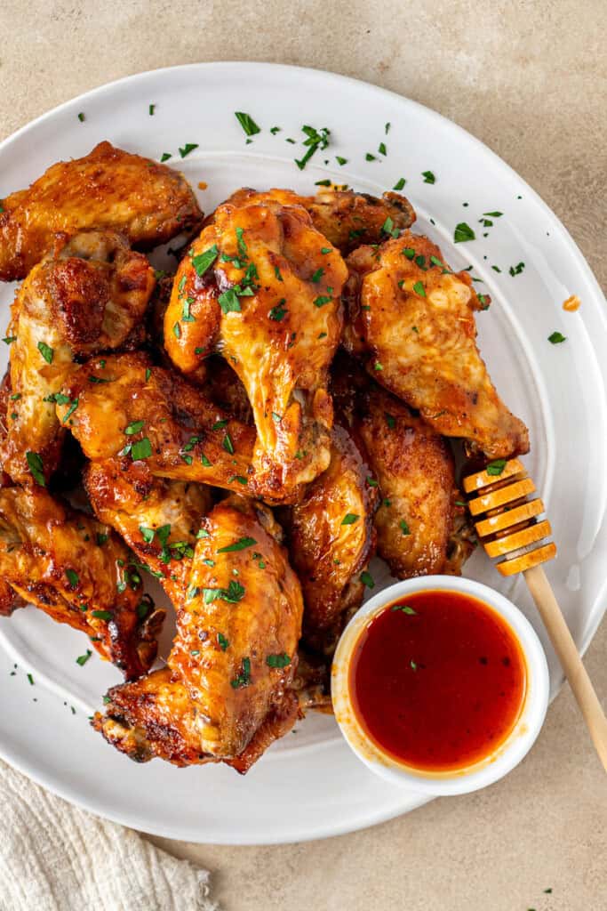 The hot honey chicken wings served up on a plate.