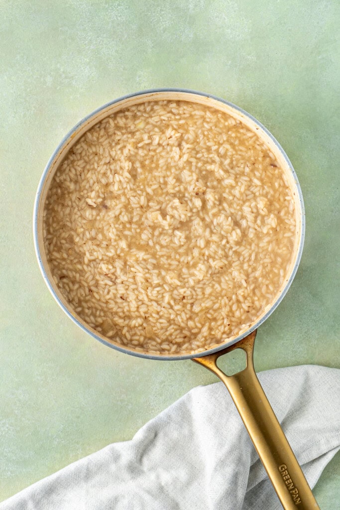 The risotto in the pan after all of the stock has been added.