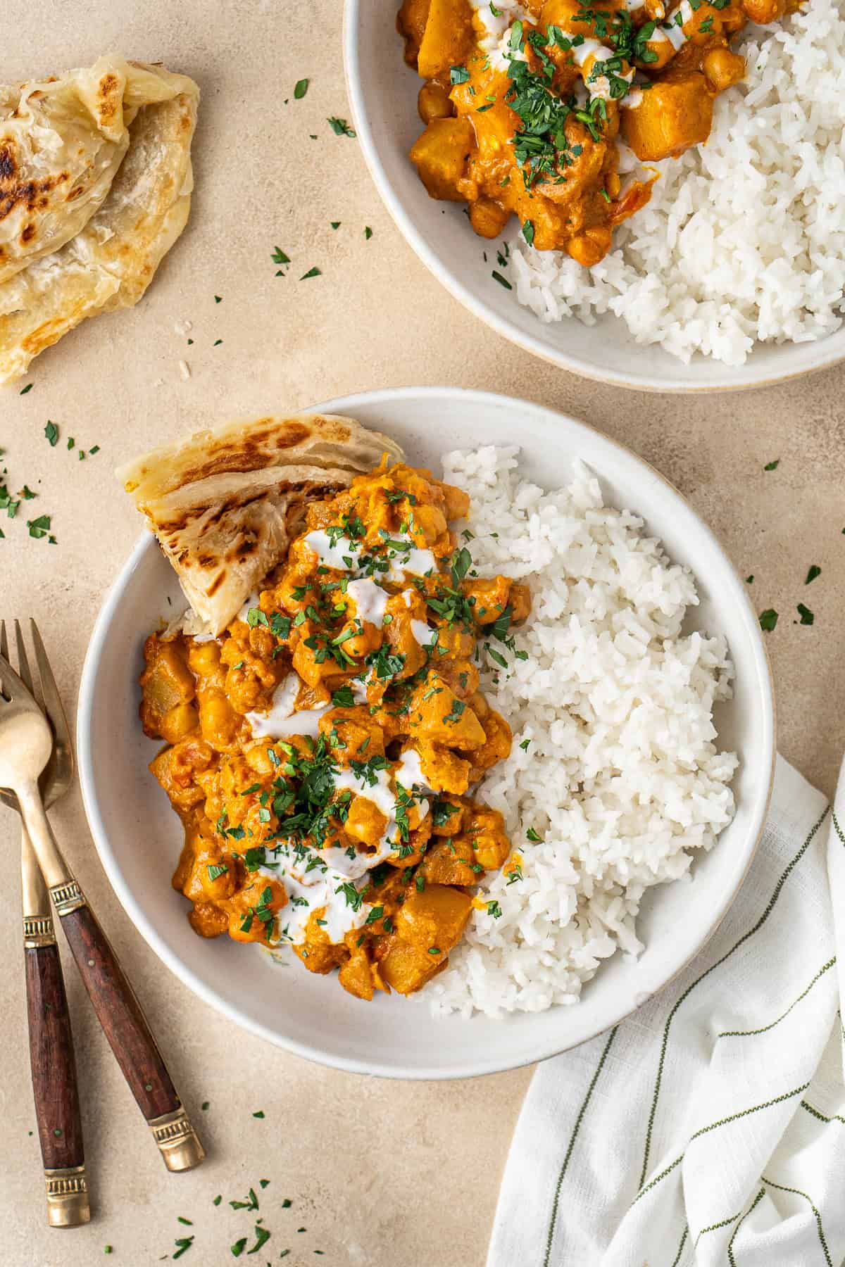 Pumpkin and chickpea curry with rice in bowls.