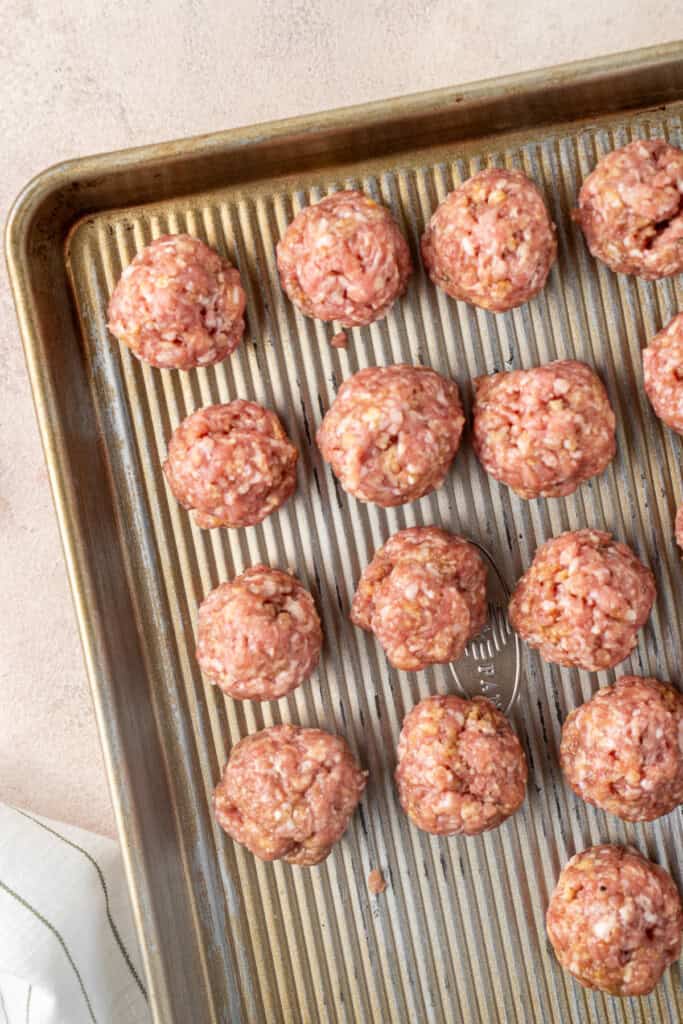 The rolled meatballs on a tray.