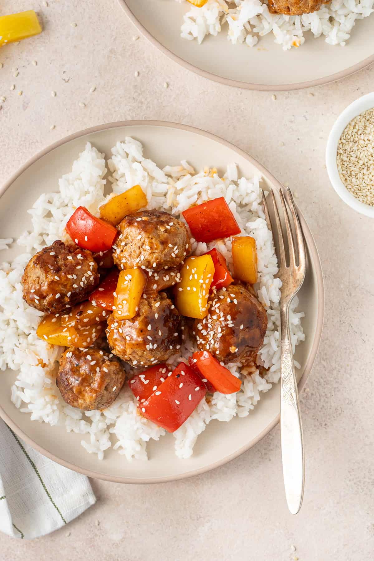 Close up of the sweet and sour pork meatballs over rice.