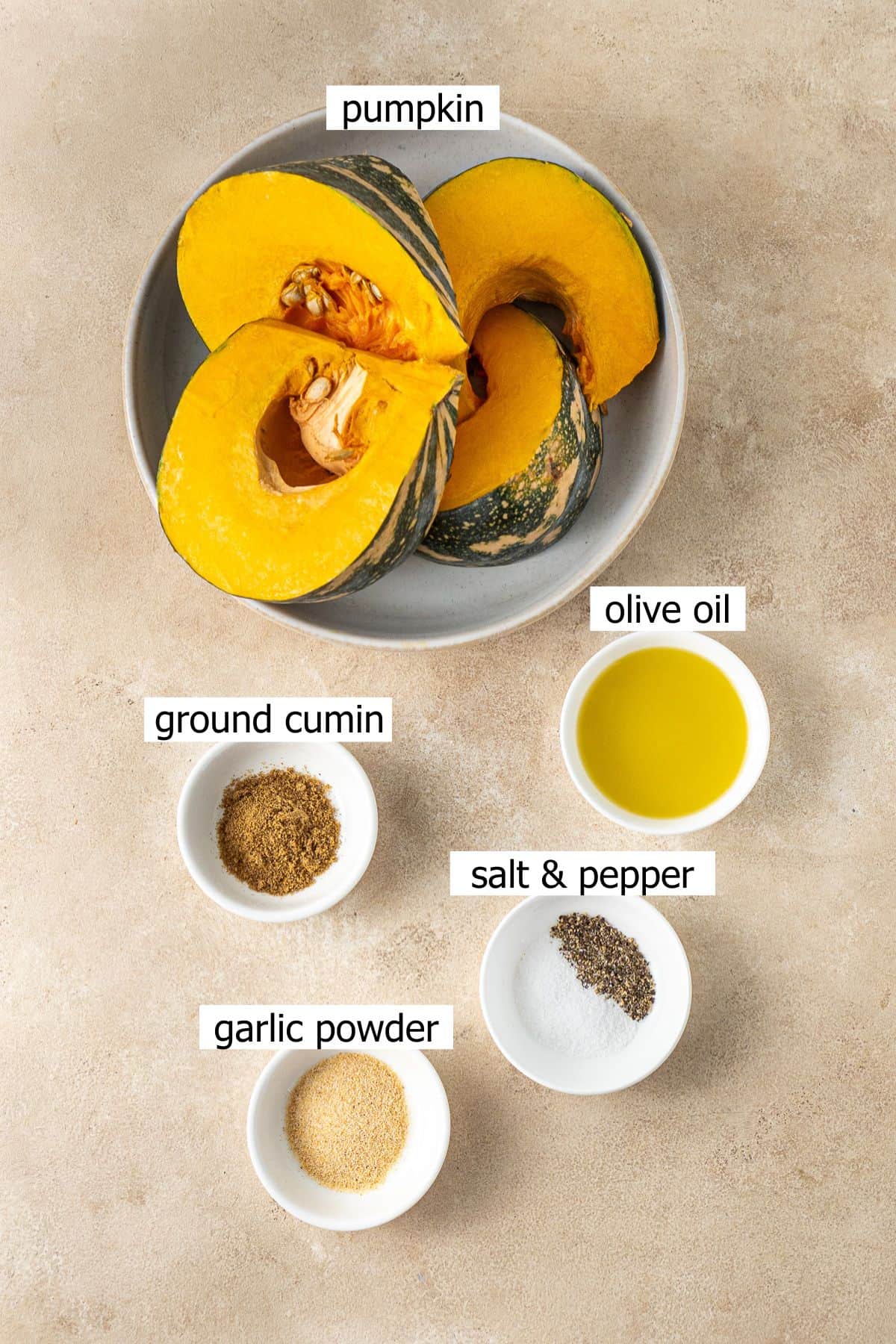 All ingredients needed to make air fryer pumpkin laid out in bowls.