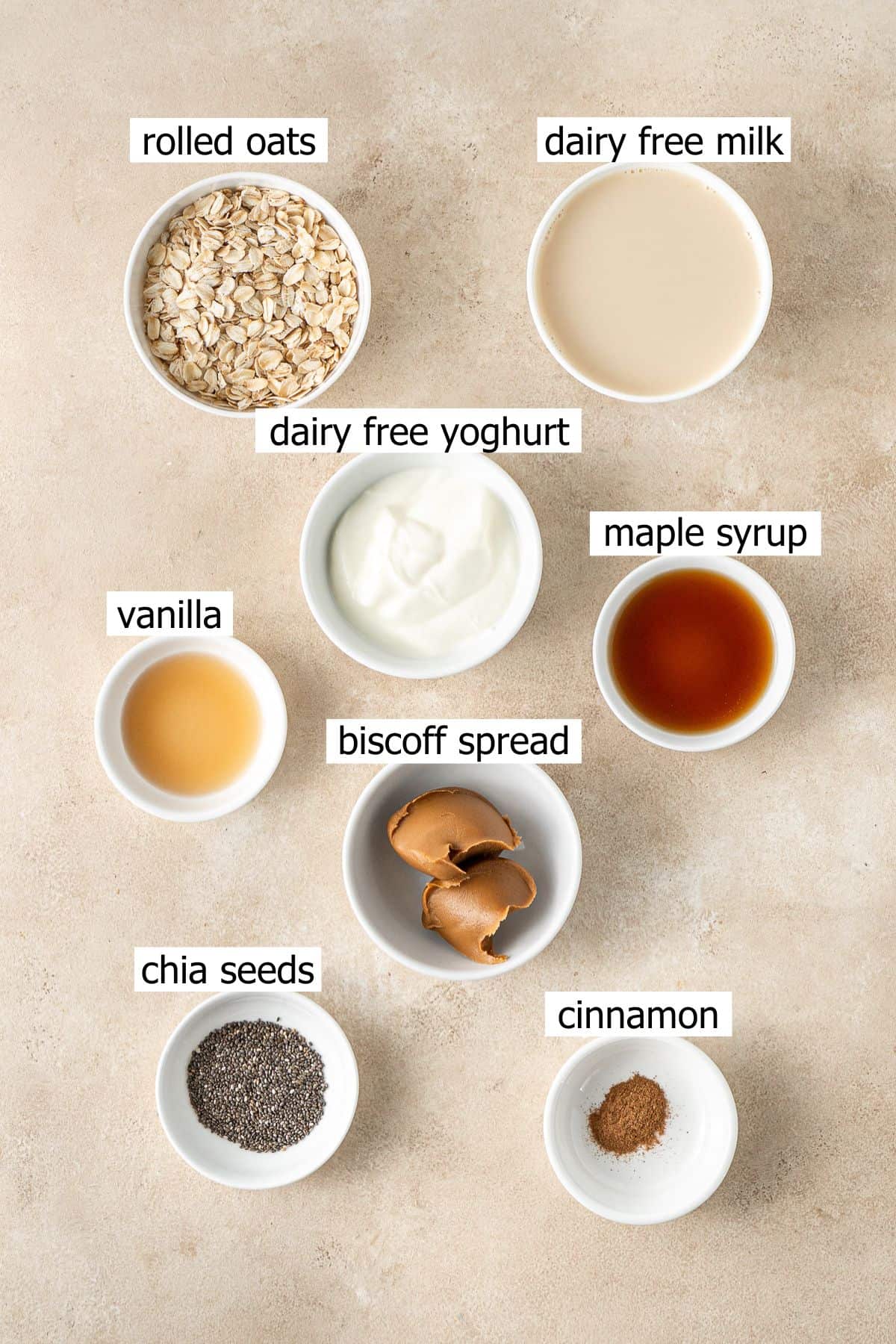 All ingredients needed to make biscoff overnight oats laid out in small bowls.