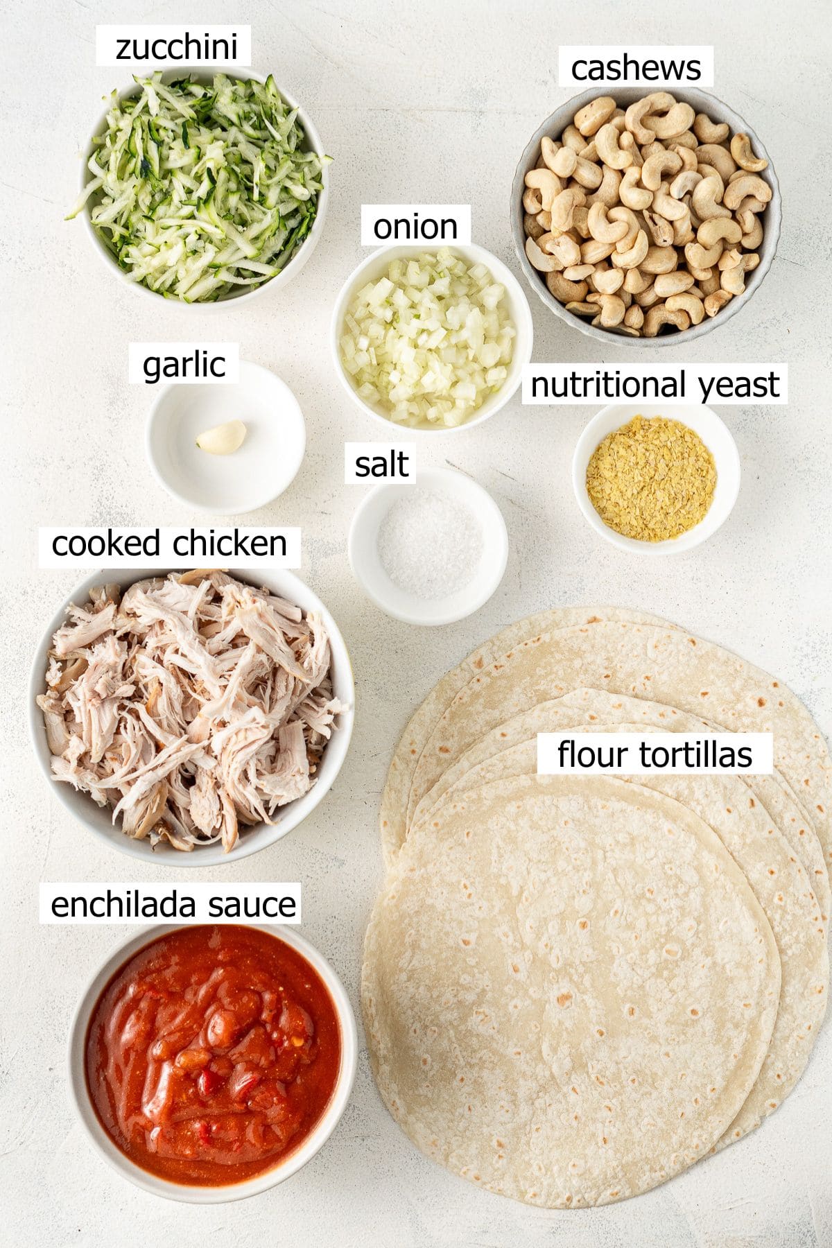 All ingredients needed to make dairy free enchiladas laid out in bowls.