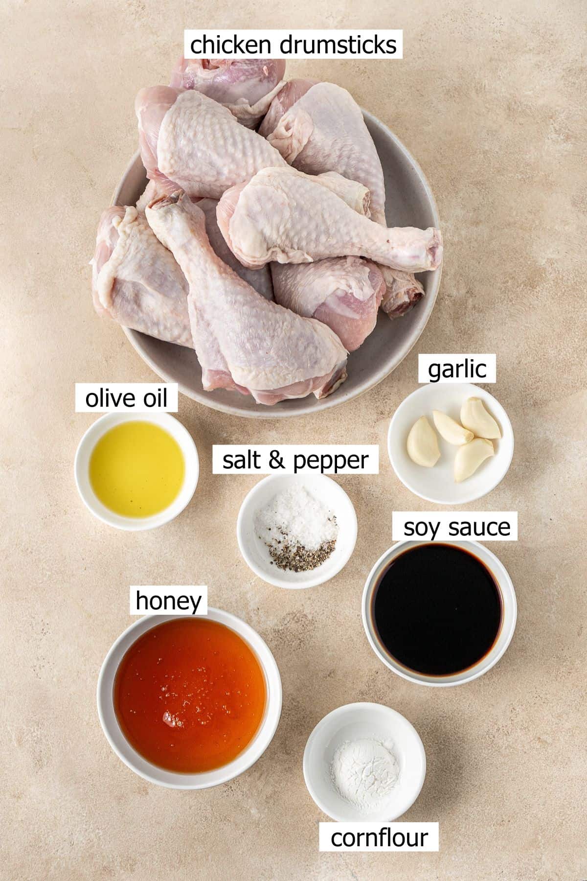 All ingredients needed to make slow cooker honey garlic chicken laid out in small bowls.