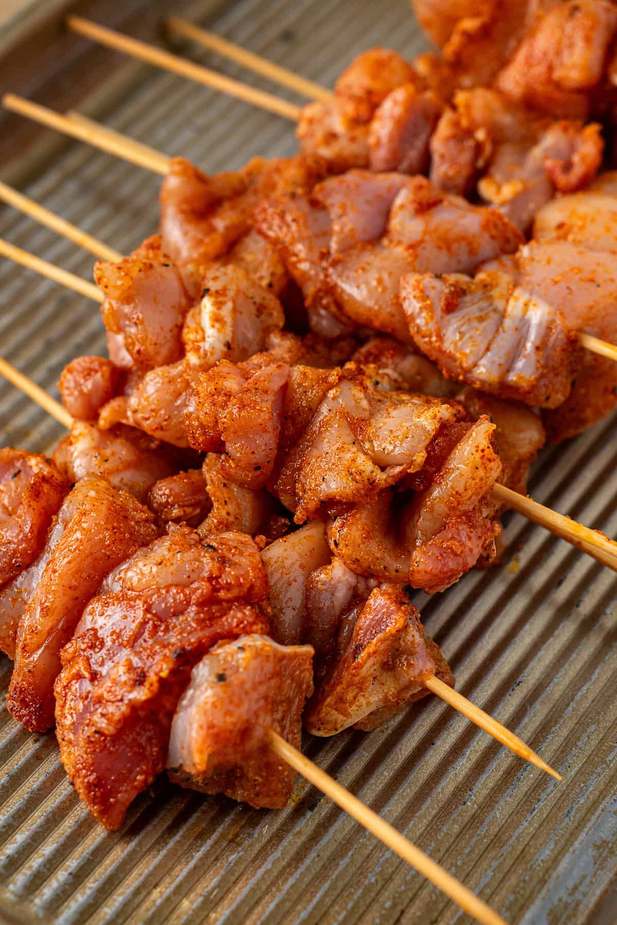 The chicken on wooden skewers. 