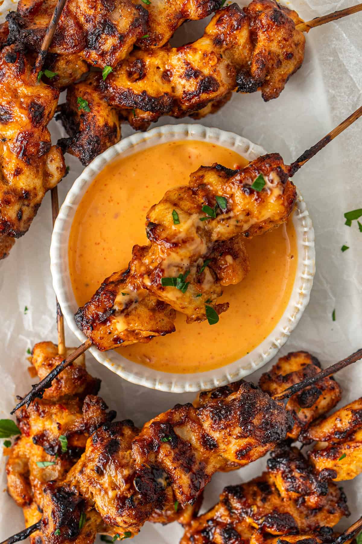 Bang bang chicken skewers with extra sauce.