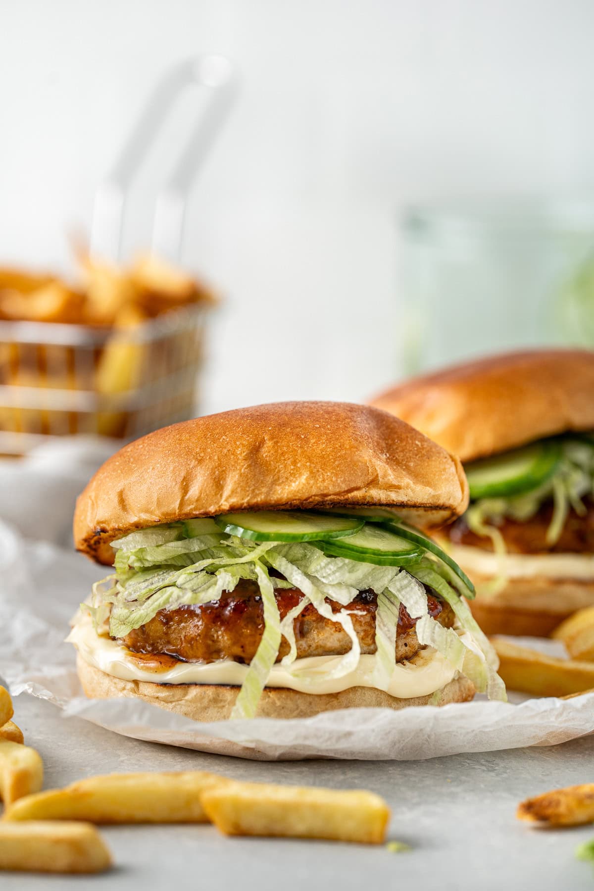 Teriyaki chicken burgers with lettuce and cucumber.