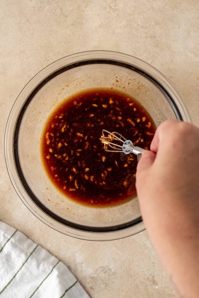 Whisking together the sauce ingredients.
