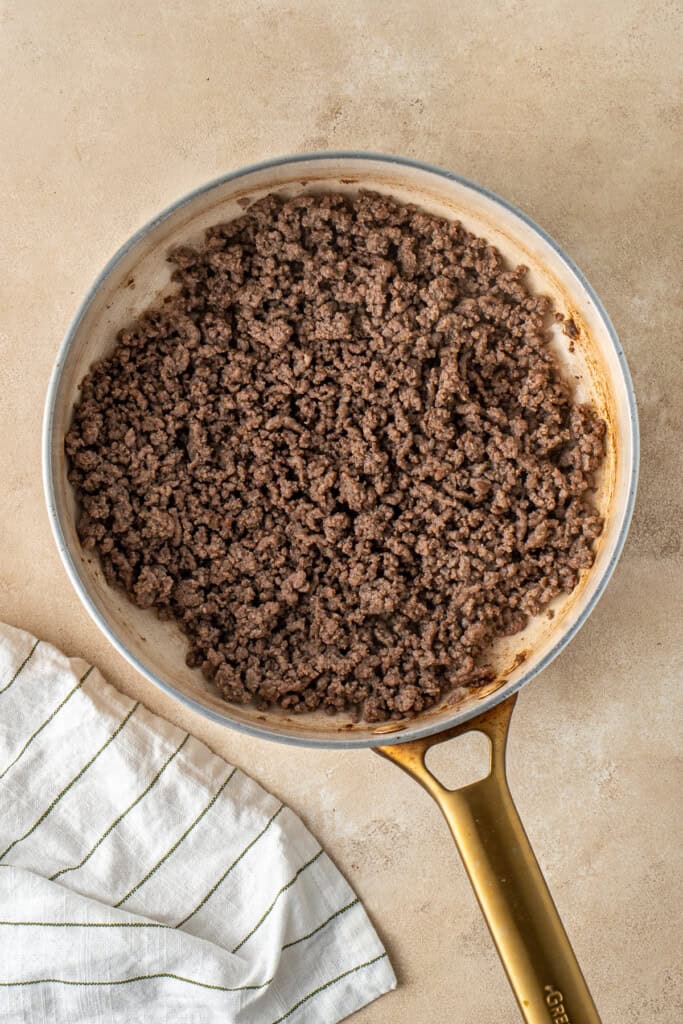 Browning the beef mince in a frying pan.