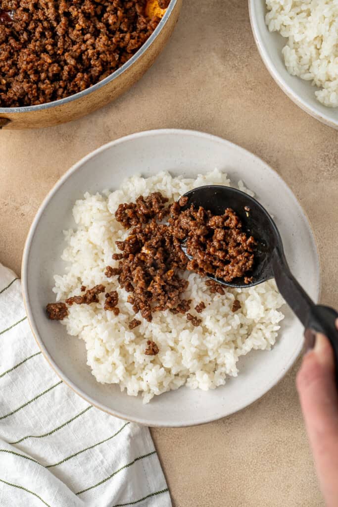 Adding the beef mince on top of the cooked rice.